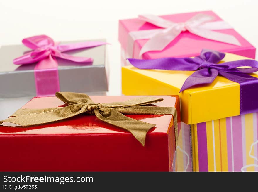 Various gift boxes on a white background, with bow