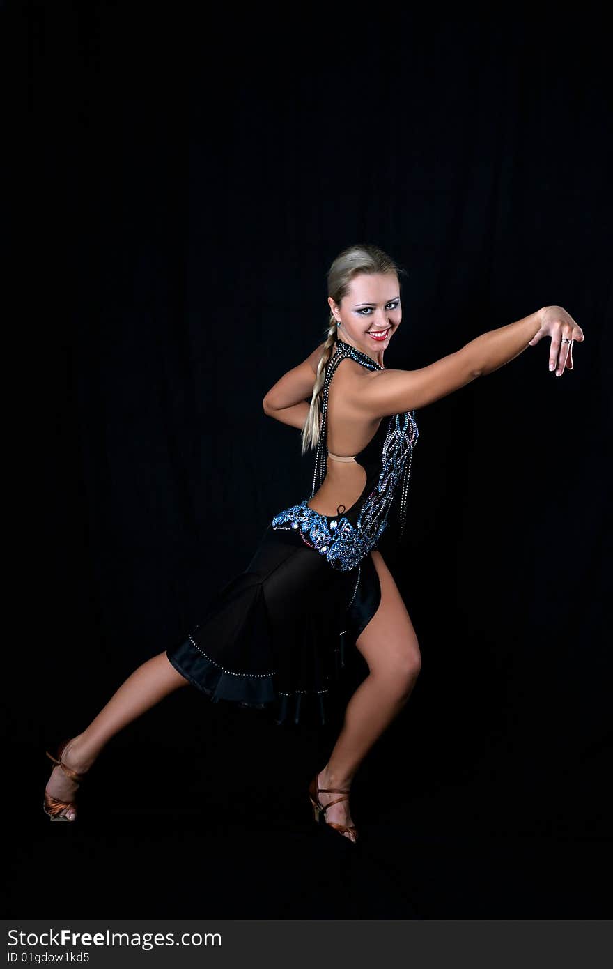 Lovely girl latino dancer against black background