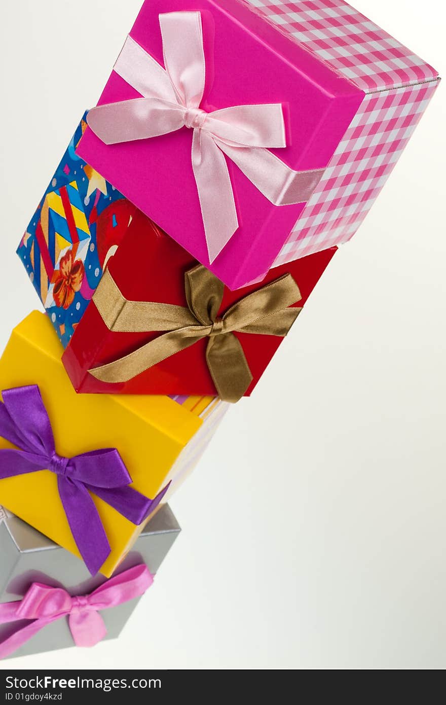 Tile of various gift boxes on a white background, with bow