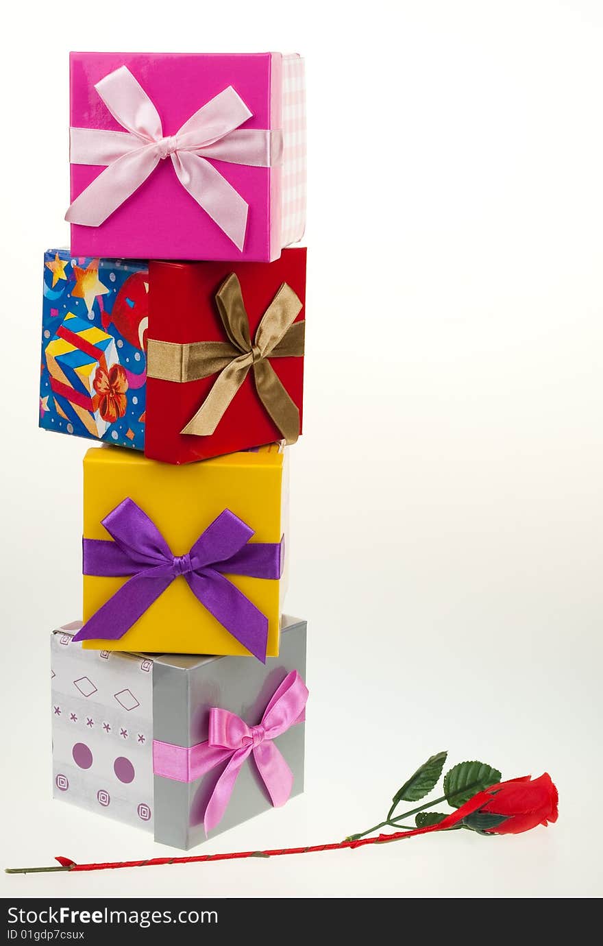 Various gift boxes on a white background, with bow and rose. Various gift boxes on a white background, with bow and rose