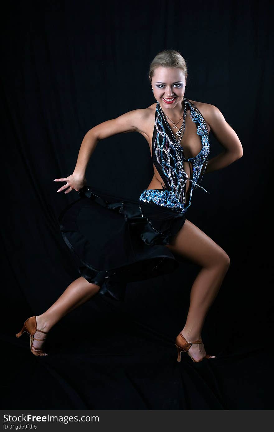 Blondie girl latin dancer against black background