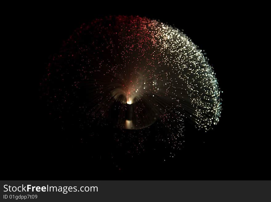 Red and white colored fiber glass lamp on a black background. Red and white colored fiber glass lamp on a black background