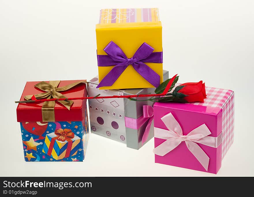 Various gift boxes on a white background, with bow and rose. Various gift boxes on a white background, with bow and rose