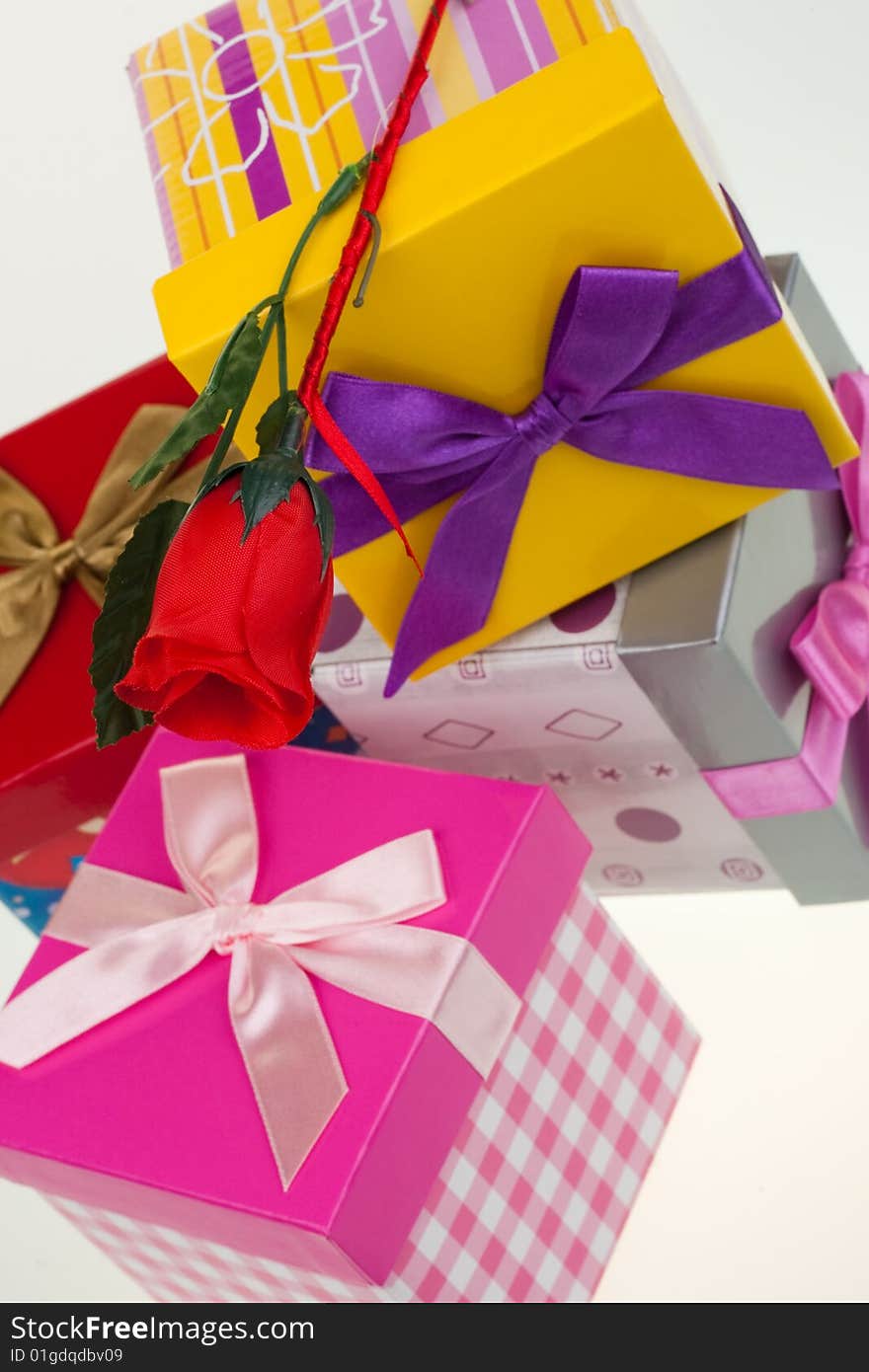 Various gift boxes on a white background, with bow and rose. Various gift boxes on a white background, with bow and rose