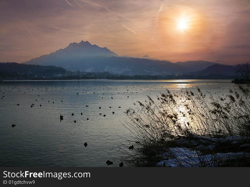 Winter Sun Over A Alpine Lake