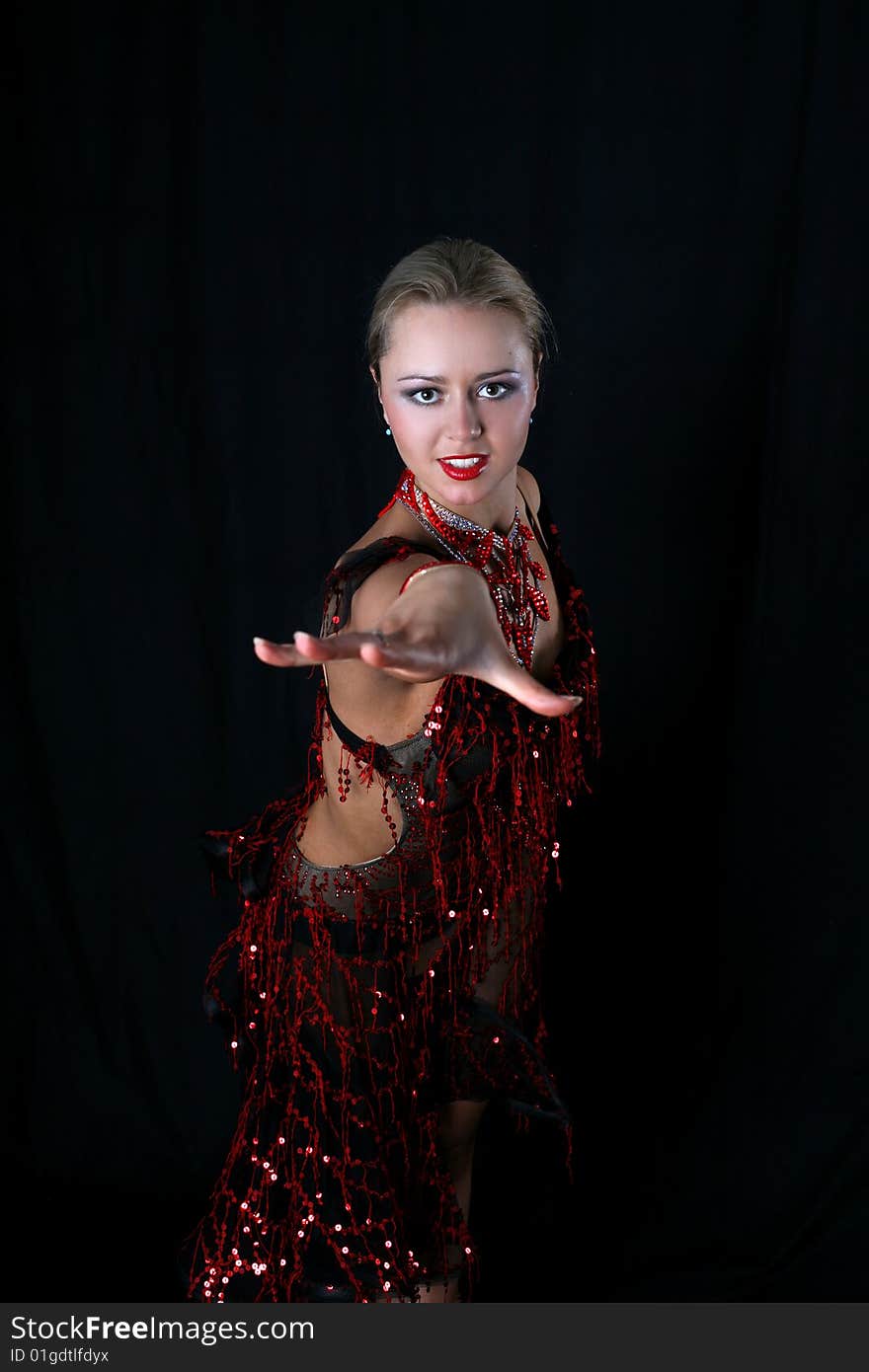 Lovely blonde latin dancer against black background