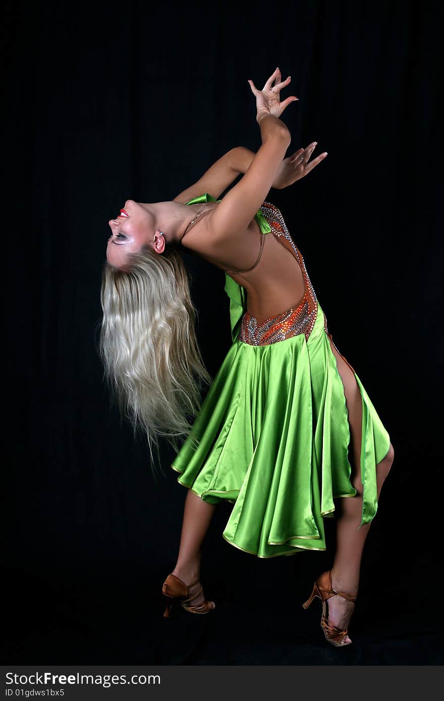 Latin dancer against black background