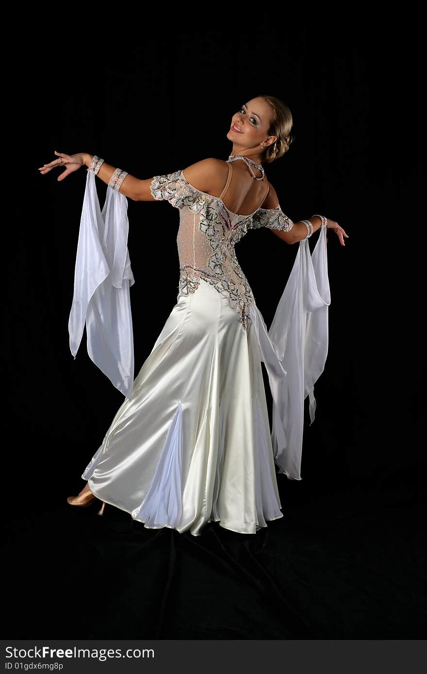 Dancer in classical blue-white dress against black background. Dancer in classical blue-white dress against black background