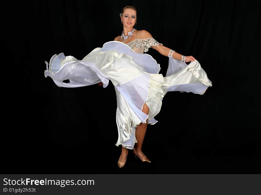 Blonde dancer in classical blue-white dress against black background