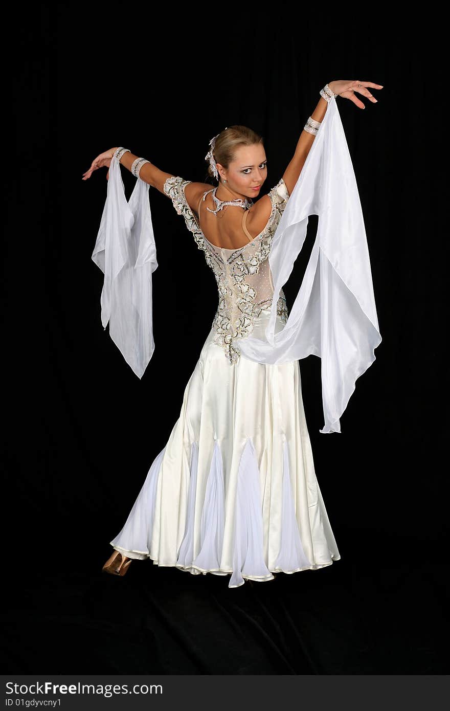 Dancer in classical blue-white dress against black background