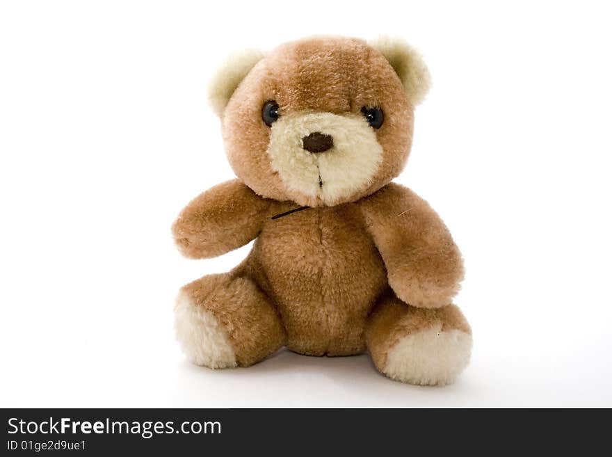 Plush bear sits against the white background. Plush bear sits against the white background