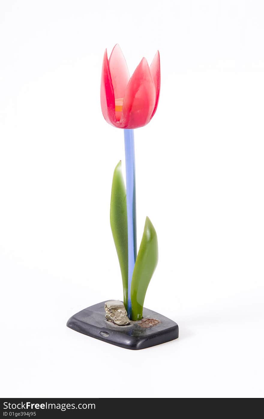 Flower made of glass with green leaves and red blossoms