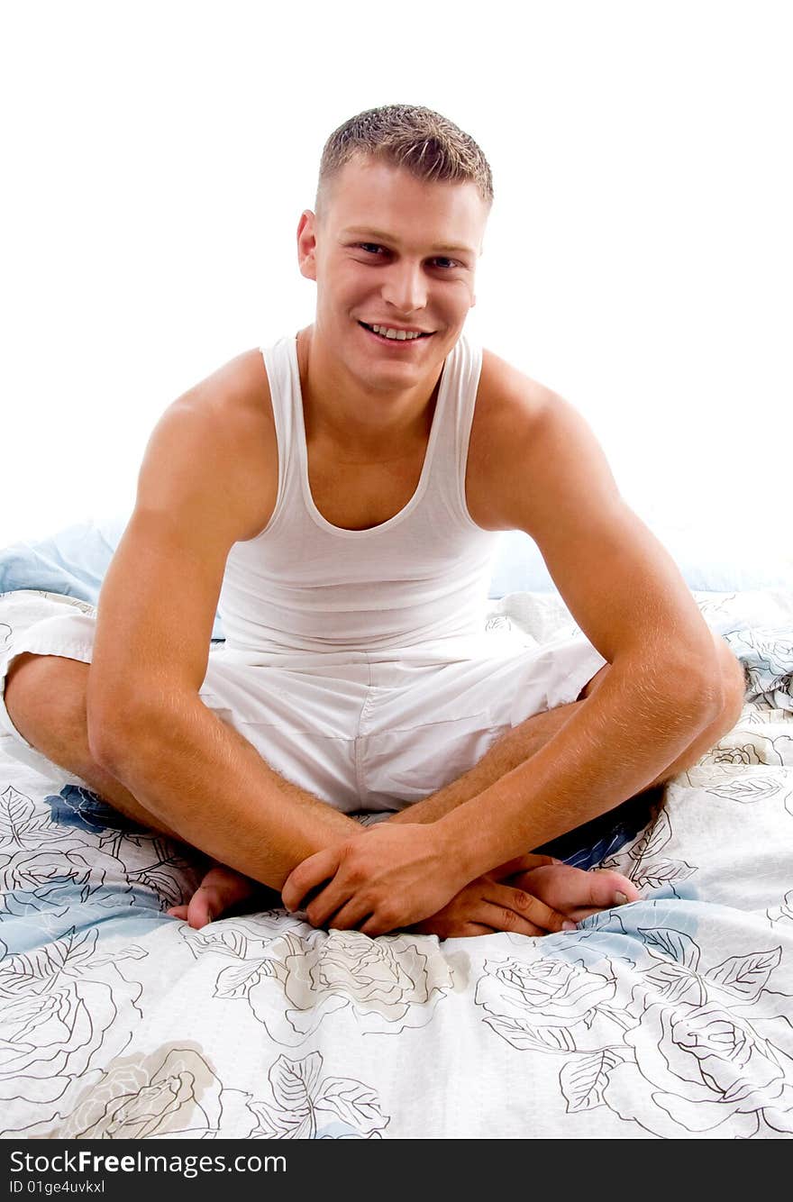 Man Sitting On Bed And Looking At Camera