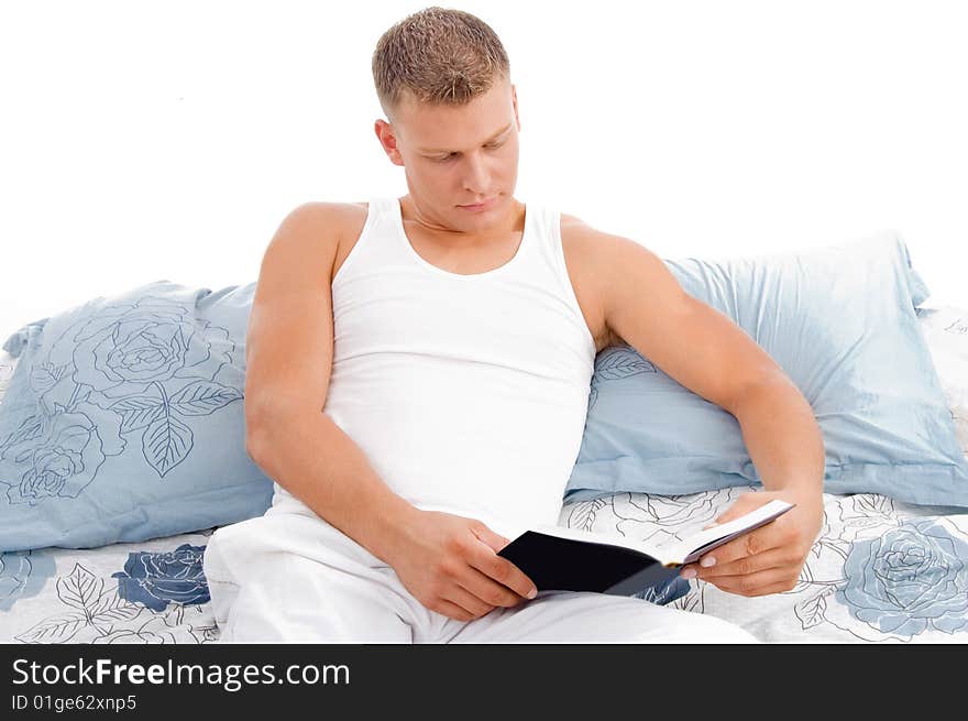 Reading book - male reading in bed relaxing