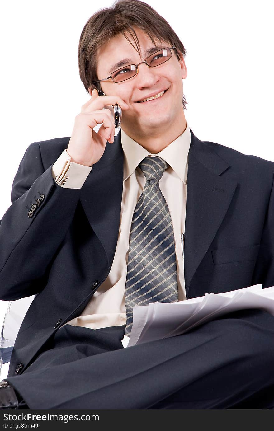 Young businessman looks documents and calling by cellular phone. Over white. Young businessman looks documents and calling by cellular phone. Over white