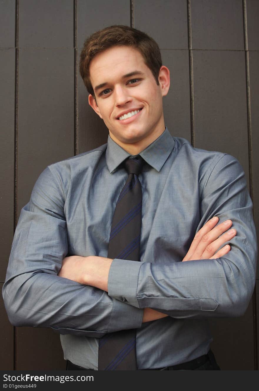 Confident young Businessman smiling with arms crosssed. Confident young Businessman smiling with arms crosssed