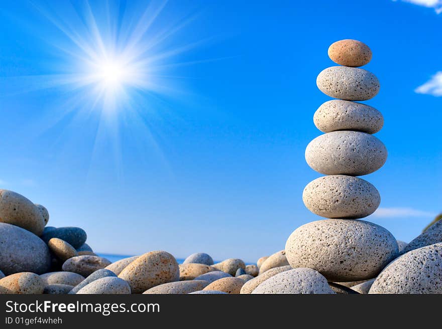 Round stones on a background of blue sky