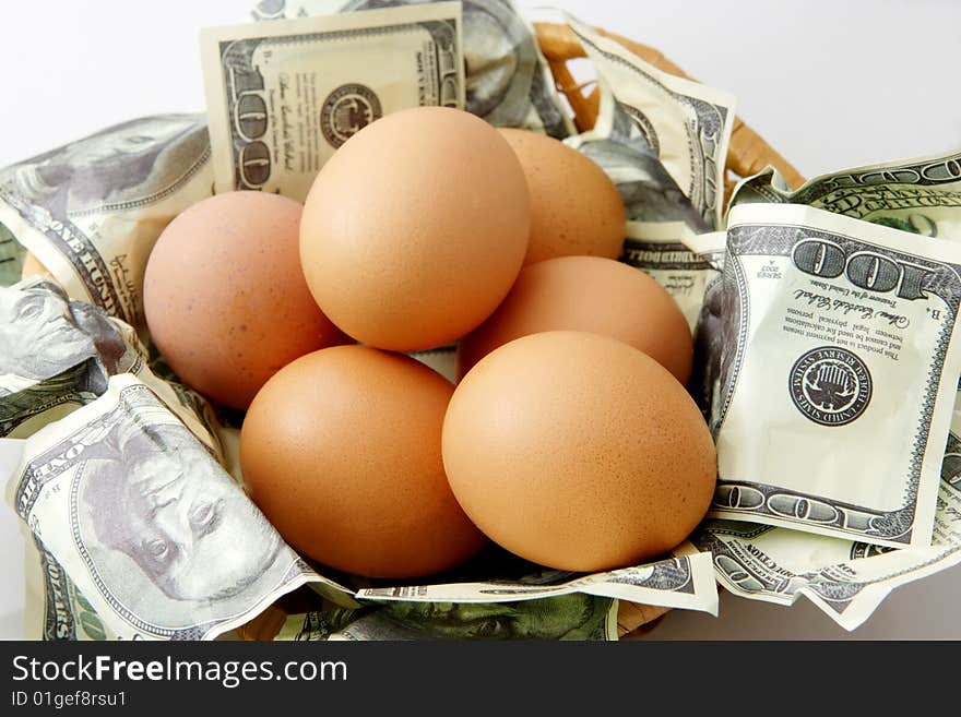 Conceptual saving images; eggs in basket of 100 dollar bills. Conceptual saving images; eggs in basket of 100 dollar bills.