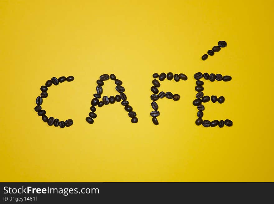 Cafï¿½ Written With Beans On Yellow