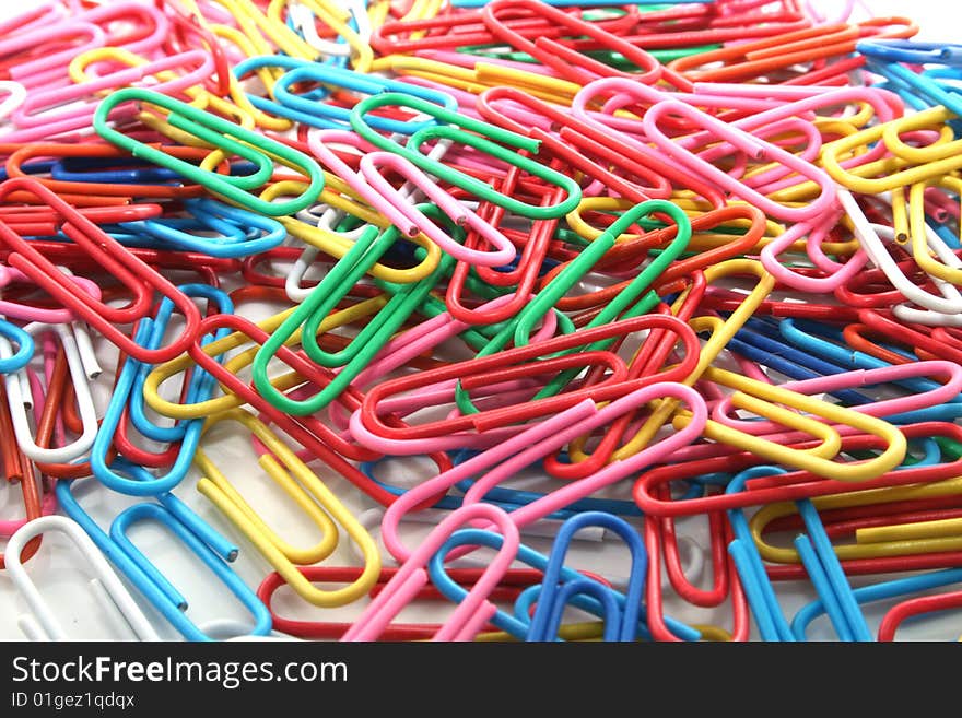 Many multi-coloured paper clips for a paper