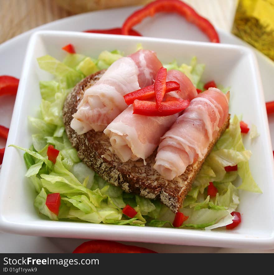 A fresh breakfast of salad with bread and ham