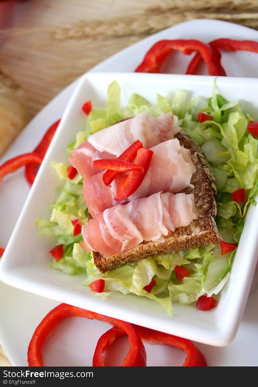 A fresh breakfast of salad with bread and ham