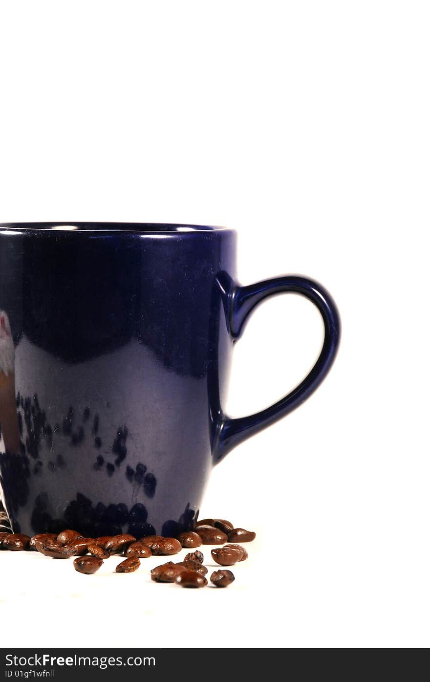 Isolated shot of coffee mug and beans