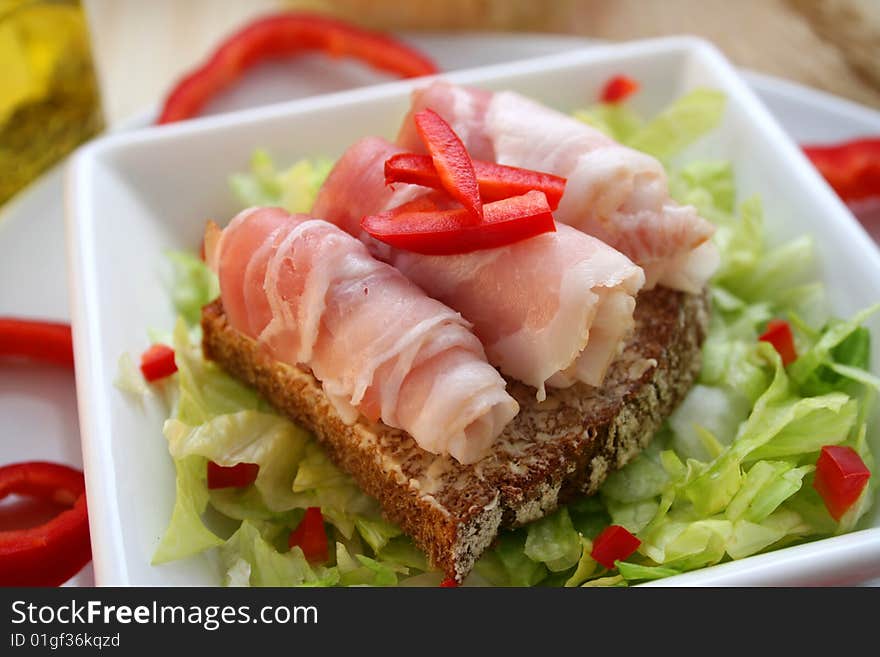 A fresh breakfast of salad with bread and ham