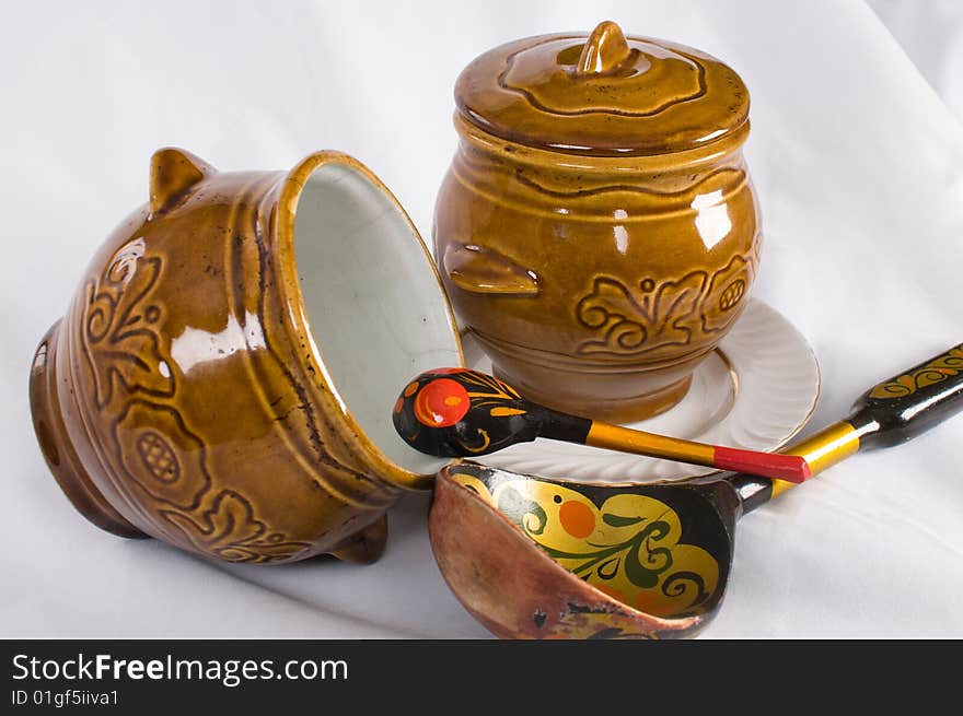 Ceramic pots for cooking and two wooden spoons. Ceramic pots for cooking and two wooden spoons.