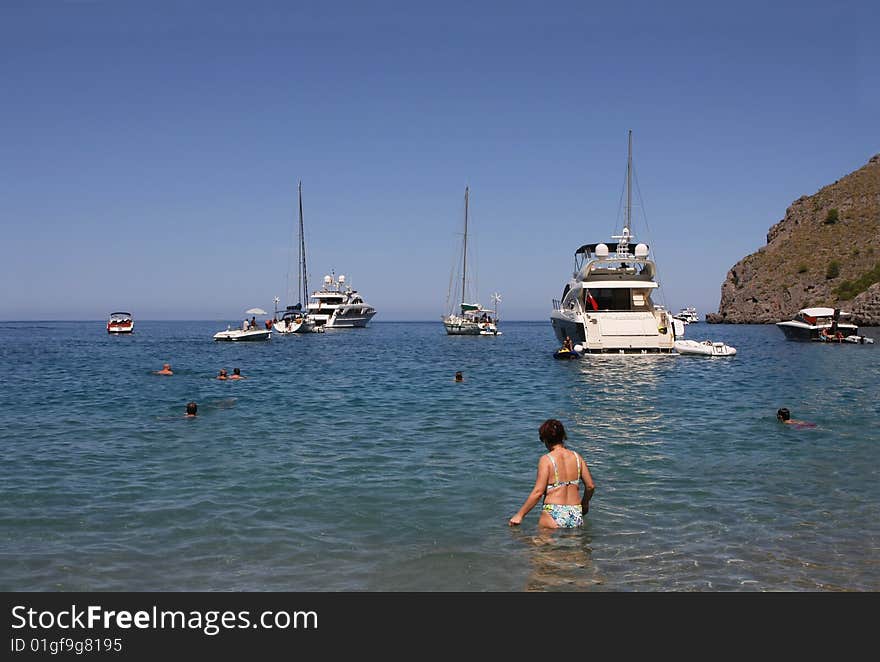 Several boats with people swiming