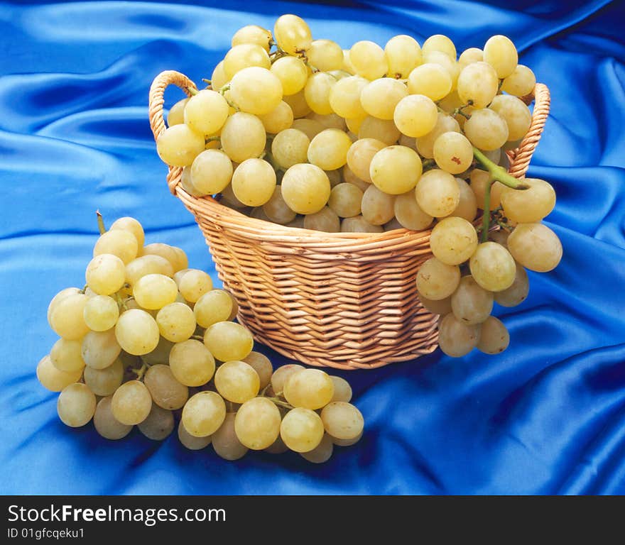 Grape in a basket with a blue background