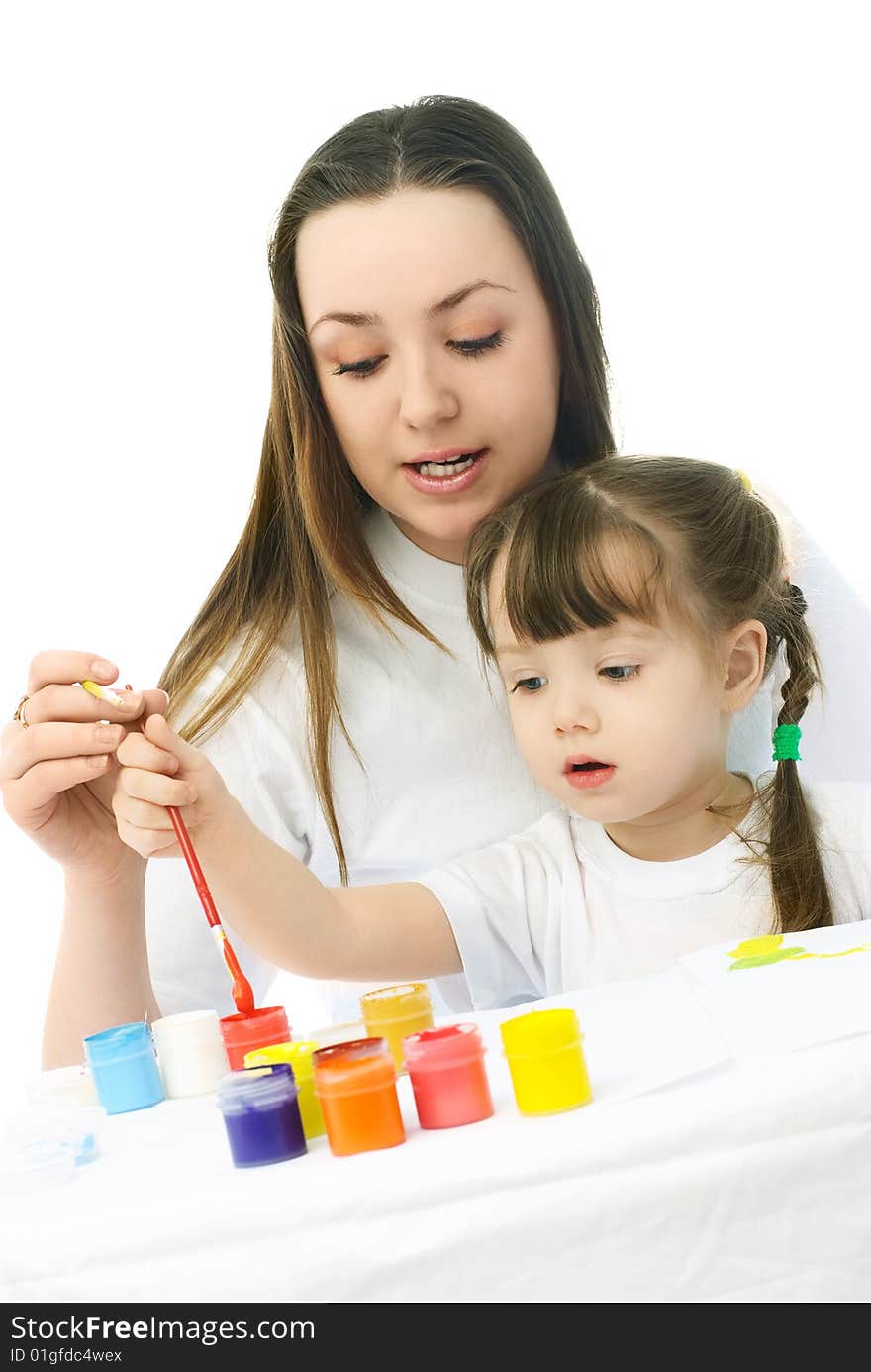 Young mother teaching her daughter painting with watercolor. Young mother teaching her daughter painting with watercolor