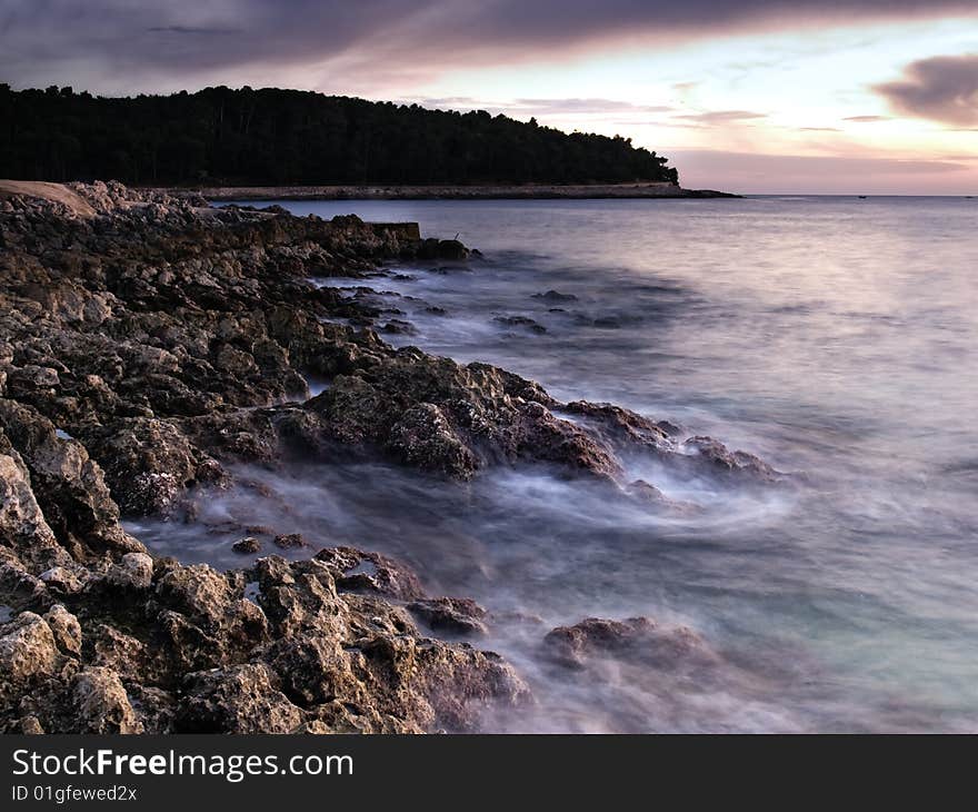 Sunset on the beach.Rocky Adriatic coast on the island Losinj, Croatia. This portfolio contains mono toned version of this image. Sunset on the beach.Rocky Adriatic coast on the island Losinj, Croatia. This portfolio contains mono toned version of this image.