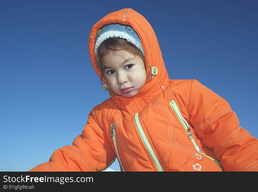 Child in their own daydream on background blue sky