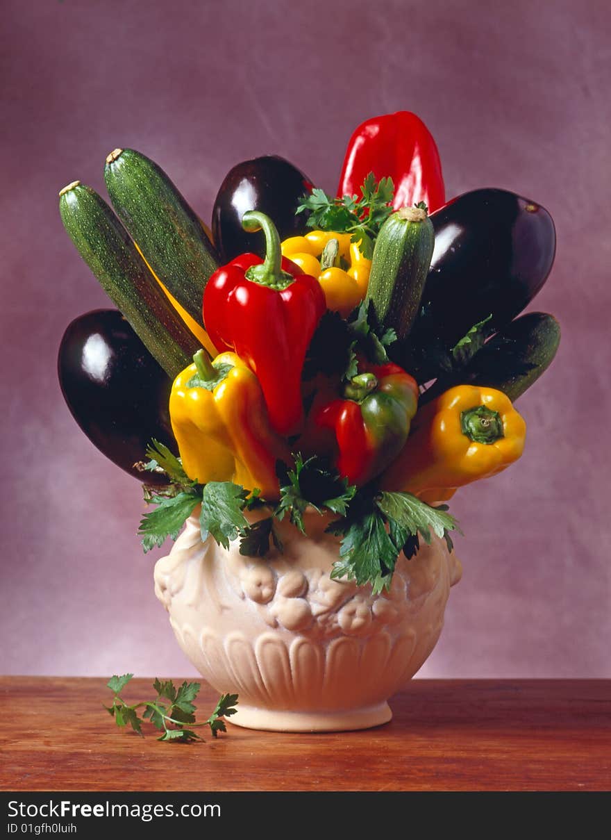 Jar with vegetables on a table made of wood with a purple background.