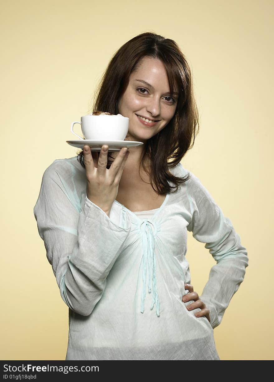 Young laughing woman with long brown hair and a cup of coffee. Young laughing woman with long brown hair and a cup of coffee