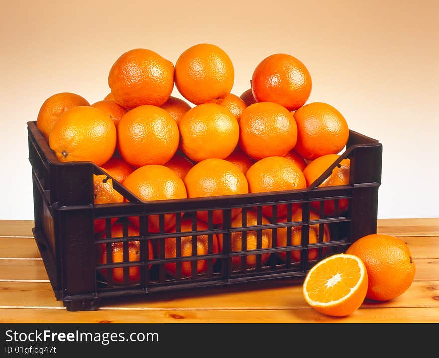 Oranges on a table made of wood.