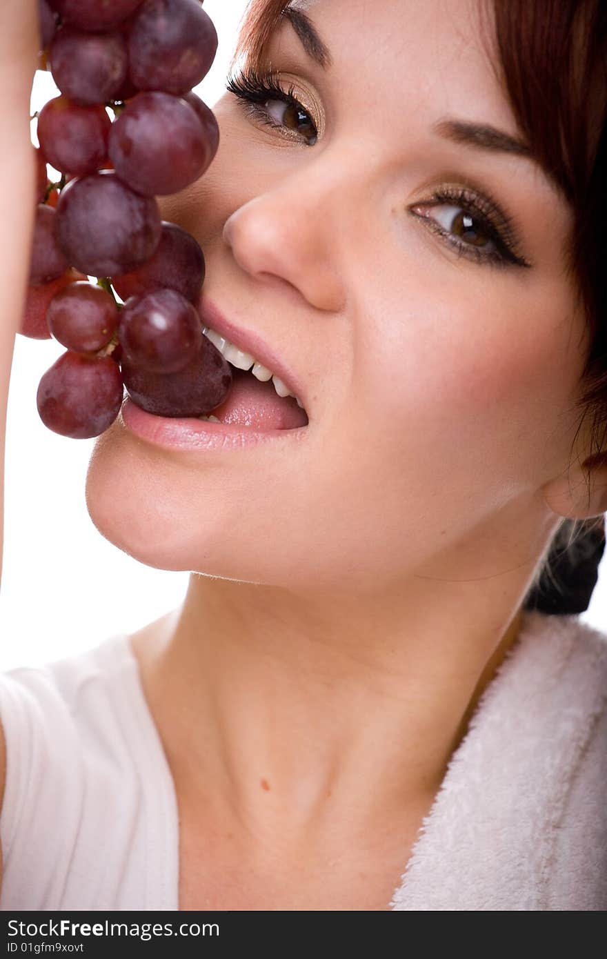 Attractive woman with grapes. over white background