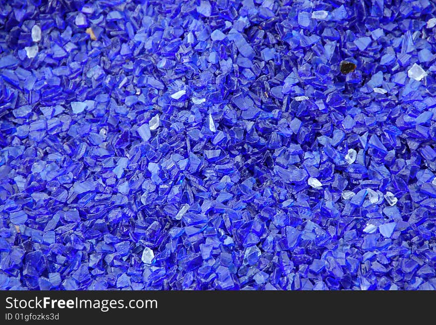 Decorative bright blue glass pieces closeup background. Decorative bright blue glass pieces closeup background