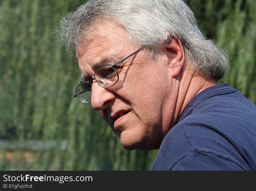 Baby boomer man smiling with gray hair and glasses