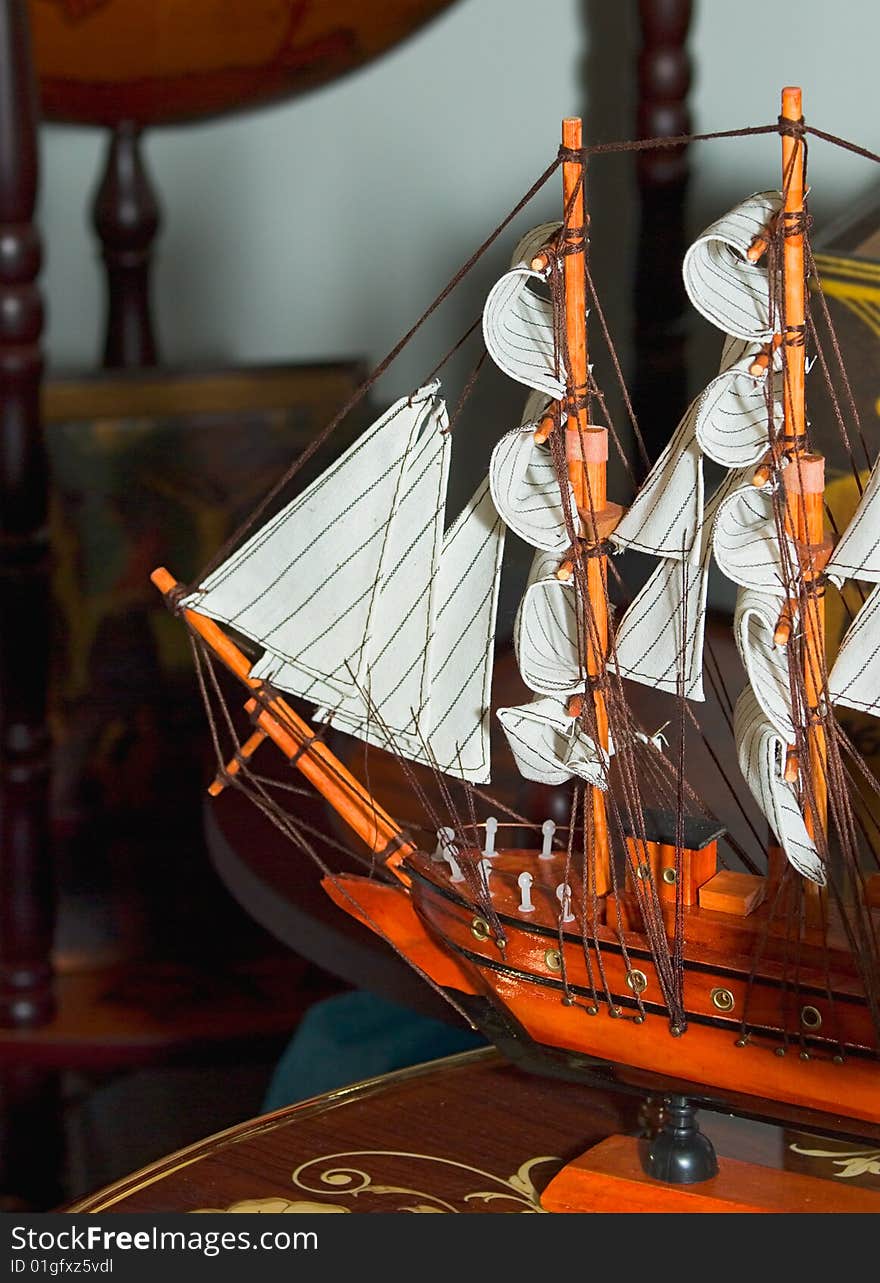 Model sailing ship is on the table