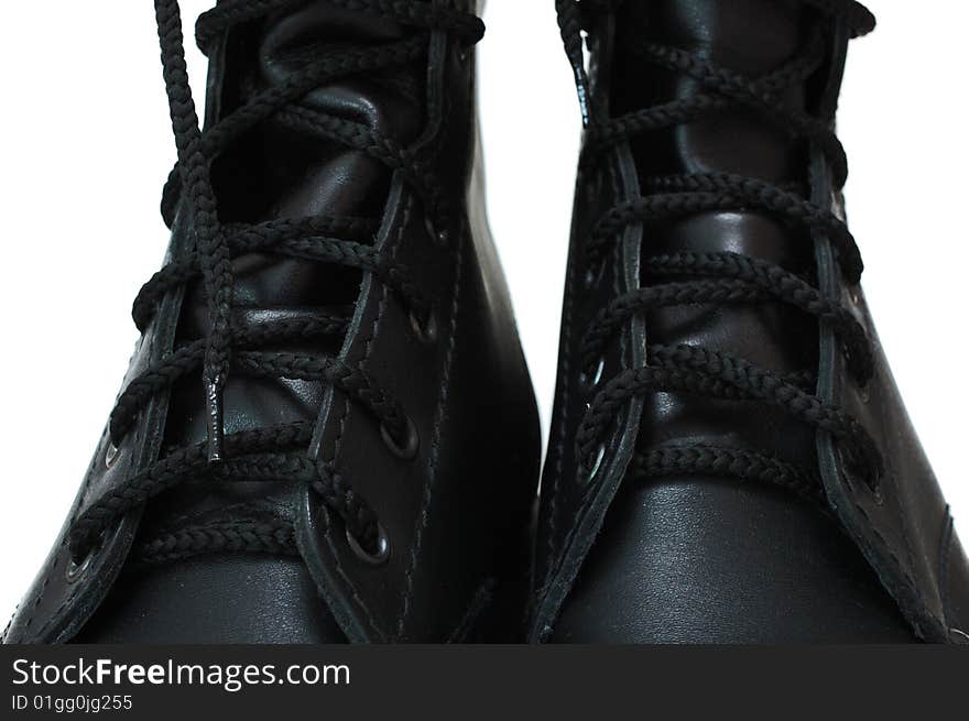 Two black leather army boots on isolated (white) background. Two black leather army boots on isolated (white) background.