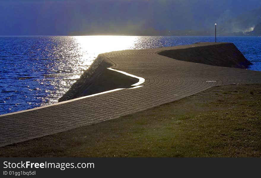 Sidewalk along the lake with streetlight