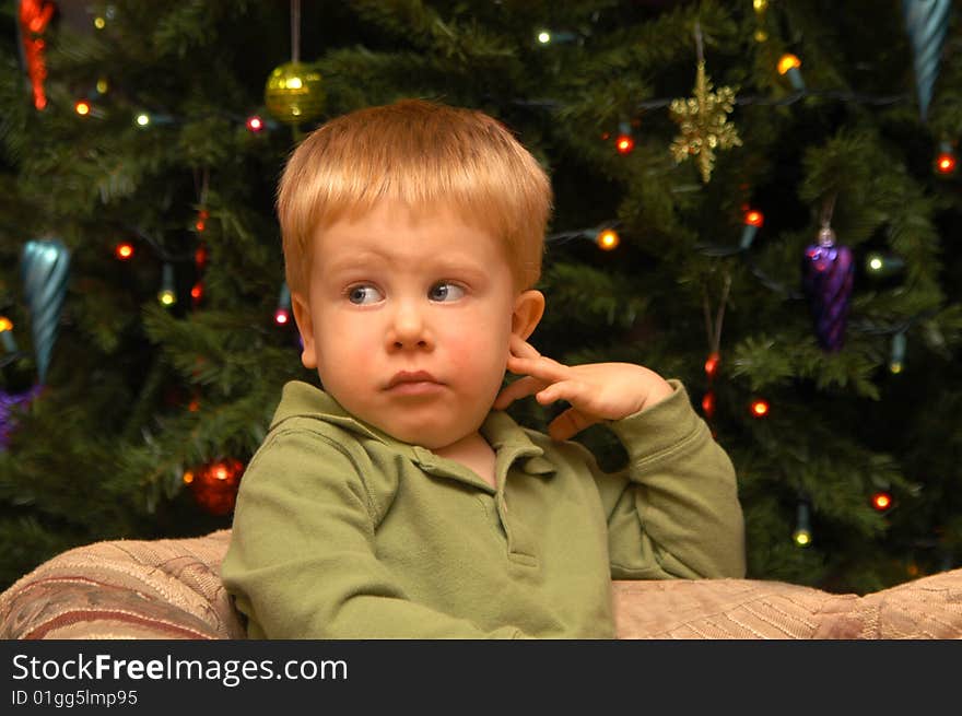 A two-and-a-half year old boy patiently awaits his portrait to be photographed. A two-and-a-half year old boy patiently awaits his portrait to be photographed.