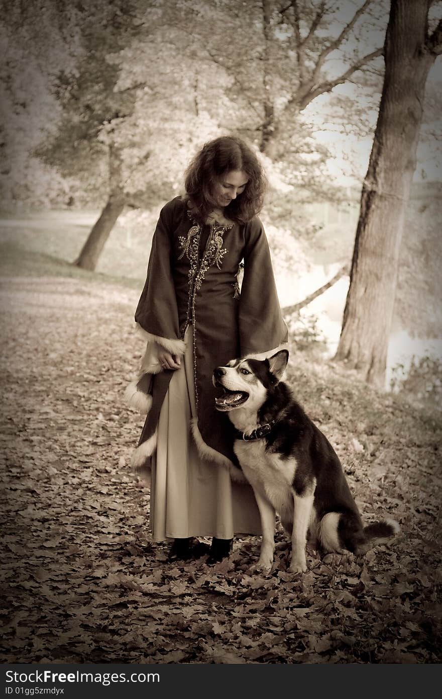 Lady in medieval dress and dog in the forest. Lady in medieval dress and dog in the forest