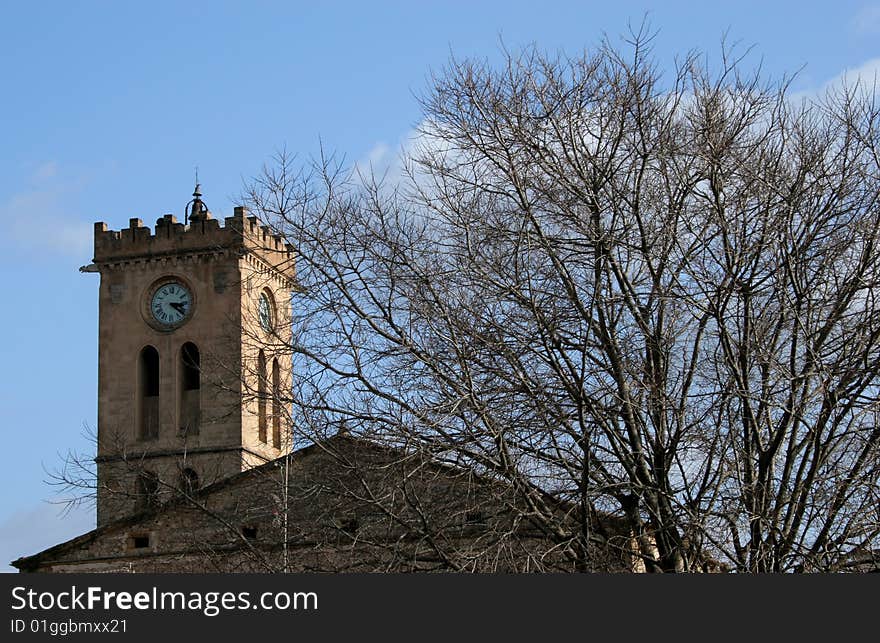 Church tower with a tree in Majorca in Spain