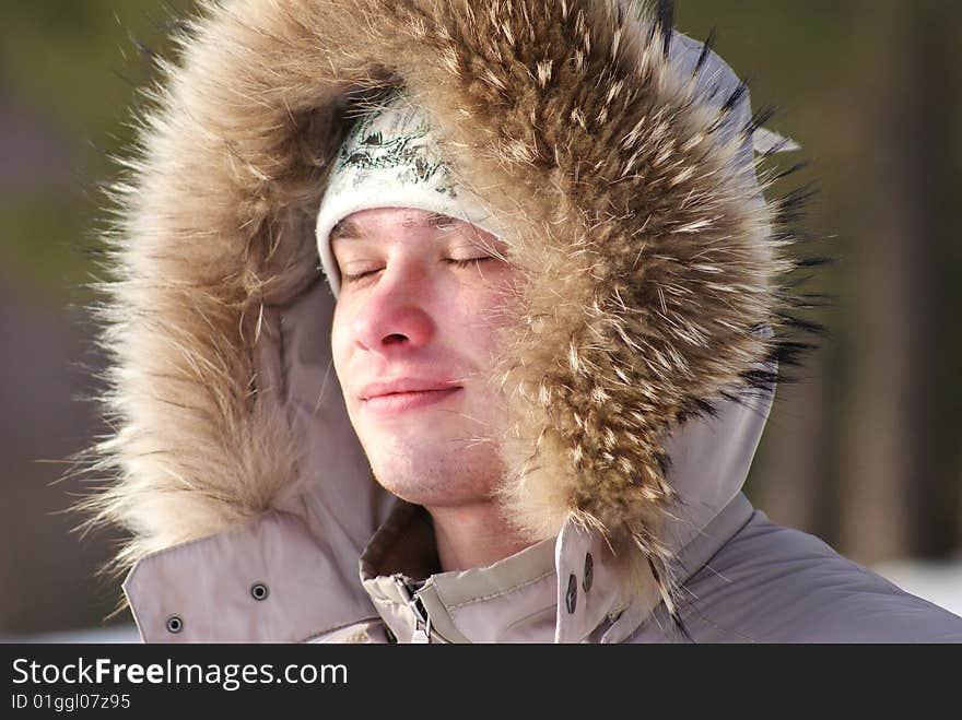 The young man enjoys winter air. The young man enjoys winter air