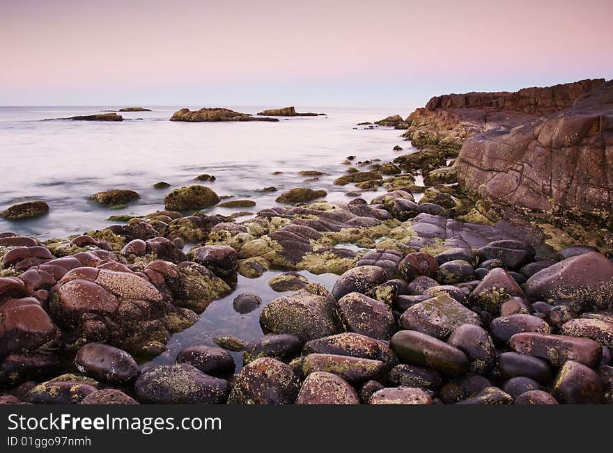 Beautiful ocean cove taken in Anna Bay, NSW, Australia during twilight conditions.