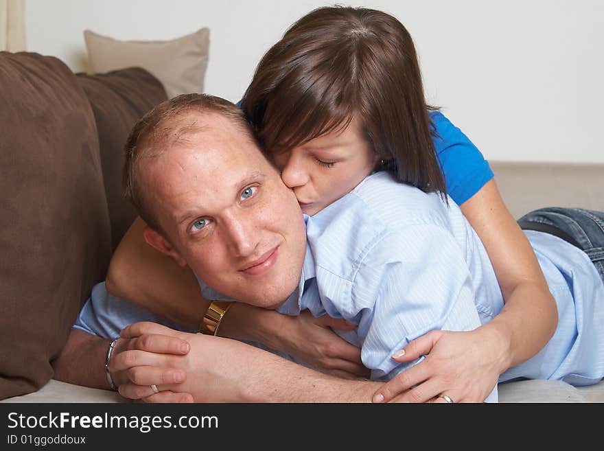 Beautiful young couple on a couch in their new appartment. Beautiful young couple on a couch in their new appartment.