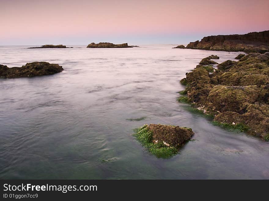 Beautiful ocean cove taken in Anna Bay, NSW, Australia during twilight conditions.